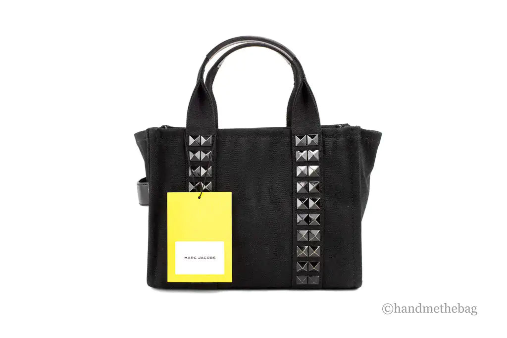 Marc Jacobs The Studded Mini Tote Black Cotton Canvas Crossbody HandbaMarc Jacobs The Studded Mini Tote – Black Cotton Canvas Crossbody HandbagMake a bold statement with Marc Jacobs The Studded Mini Tote in black cotton canvas. This stStudded Mini Tote Black Cotton Canvas Crossbody Handbag PurseStudded Mini Tote Black Cotton Canvas Crossbody Handbag Purse