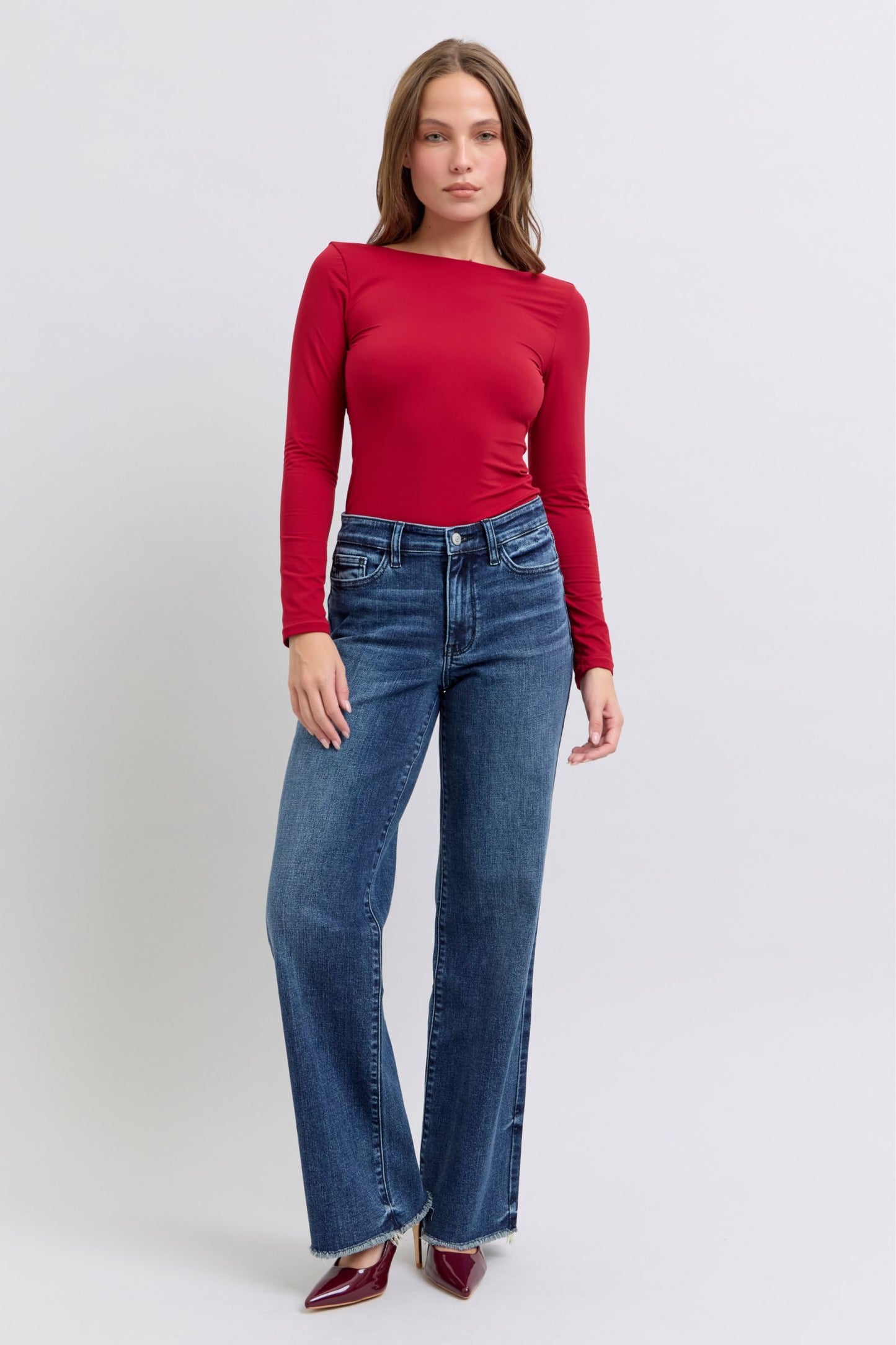 Judy Blue Full Size Raw Hem Mid Rise JeansRaw hem mid-rise jeans are a fashionable and on-trend denim style. The "raw hem" refers to the unfinished edge at the bottom of the jeans, creating a frayed or raw lJudy Blue Full Size Raw Hem Mid Rise JeansJudy Blue Full Size Raw Hem Mid Rise Jeans