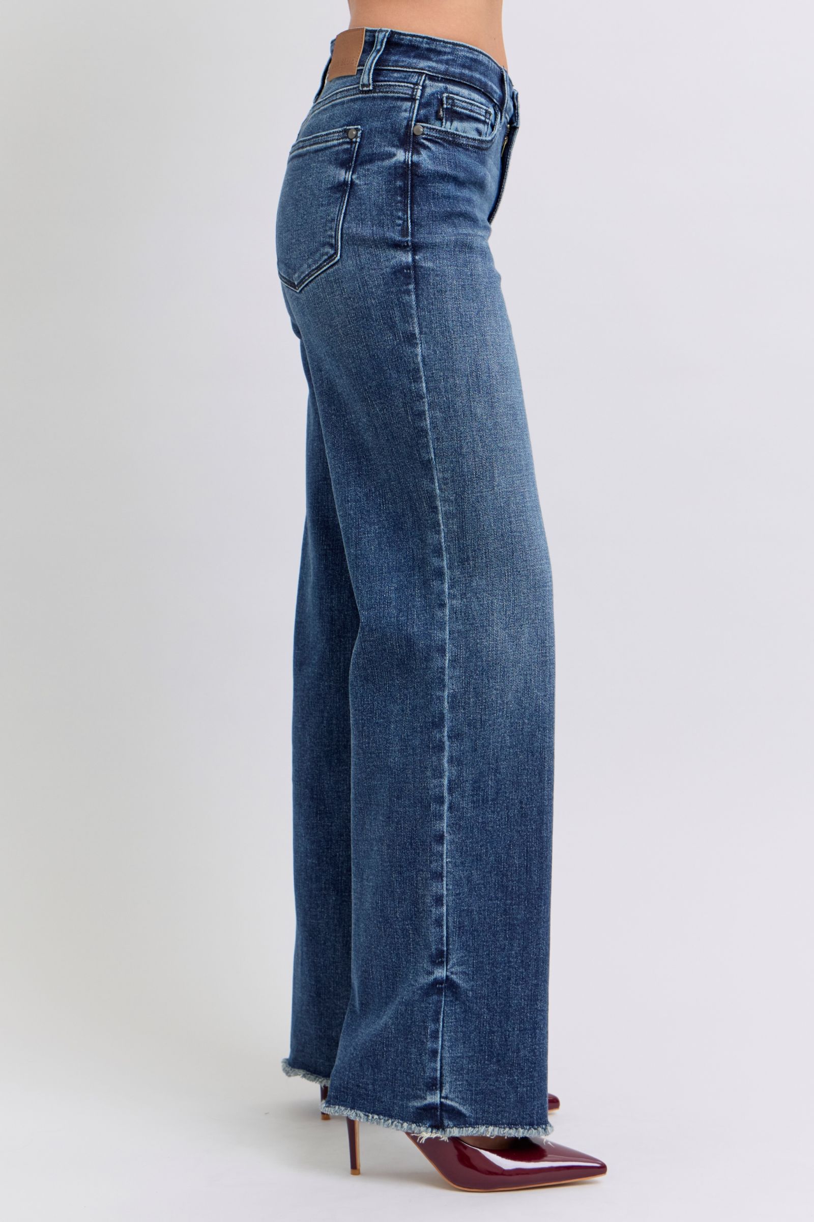 Judy Blue Full Size Raw Hem Mid Rise JeansRaw hem mid-rise jeans are a fashionable and on-trend denim style. The "raw hem" refers to the unfinished edge at the bottom of the jeans, creating a frayed or raw lJudy Blue Full Size Raw Hem Mid Rise JeansJudy Blue Full Size Raw Hem Mid Rise Jeans