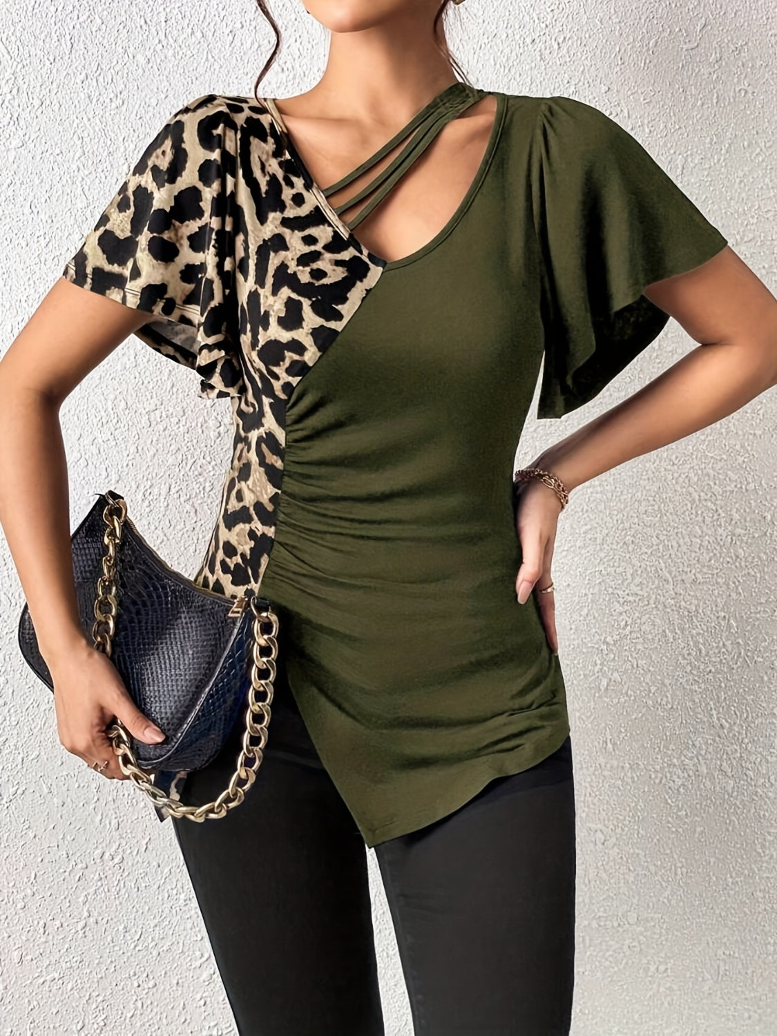 Ruched Leopard Flutter Sleeve T-ShirtIndulge in luxury with our Ruched Leopard Flutter Sleeve T-Shirt. The ruched detail and flutter sleeves add a touch of elegance to this already fierce leopard print Ruched Leopard Flutter SleeveRuched Leopard Flutter Sleeve