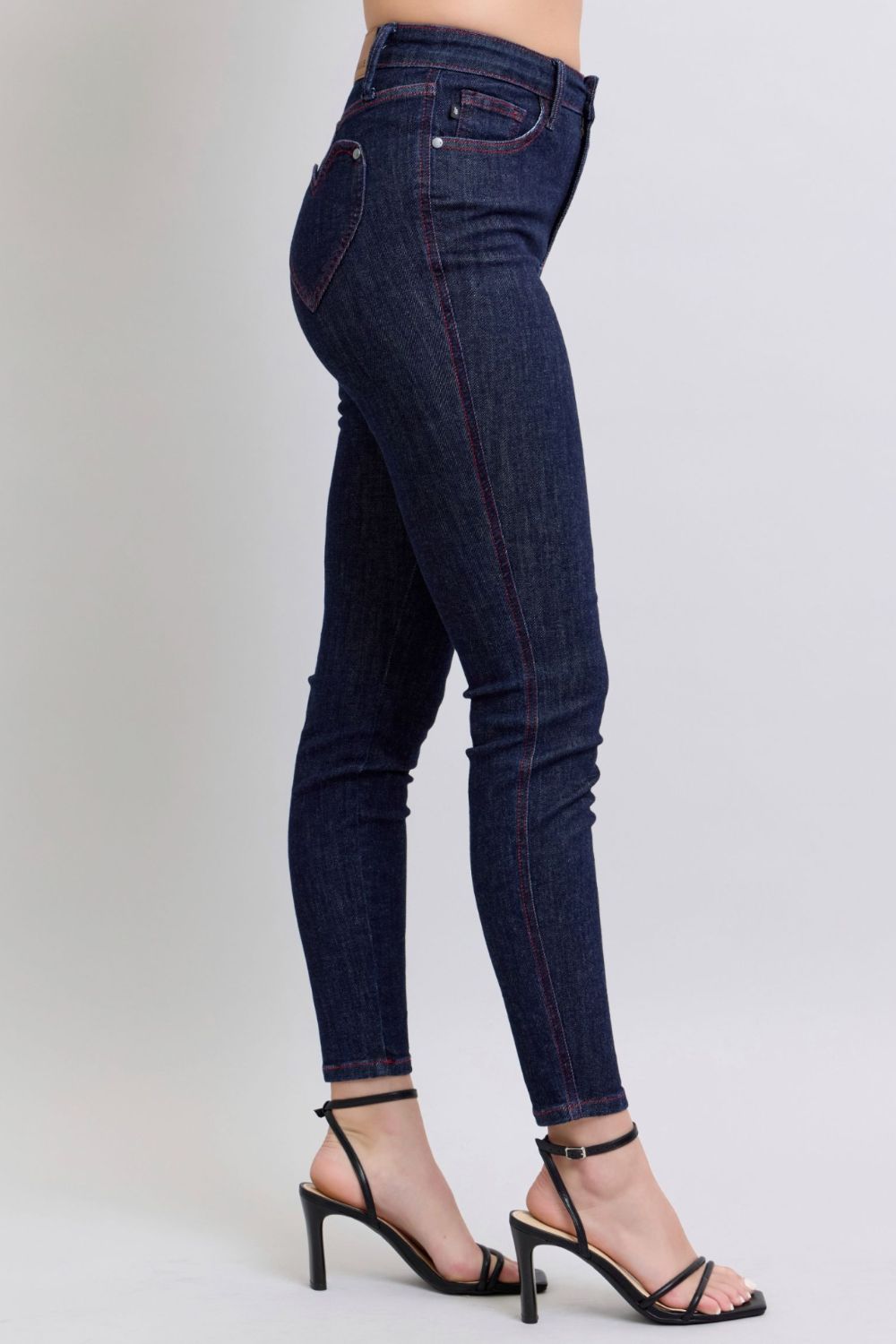 Judy Blue Full Size Heart Shaped Back Pockets Skinny JeansHigh Rise Heart-shaped back pockets on skinny jeans add a fun and playful twist to a classic style. These unique pockets can enhance your silhouette and create a flaJudy Blue Full Size Heart Shaped Back Pockets Skinny JeansJudy Blue Full Size Heart Shaped Back Pockets Skinny Jeans