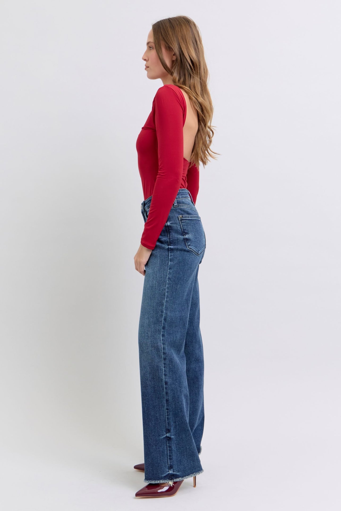 Judy Blue Full Size Raw Hem Mid Rise JeansRaw hem mid-rise jeans are a fashionable and on-trend denim style. The "raw hem" refers to the unfinished edge at the bottom of the jeans, creating a frayed or raw lJudy Blue Full Size Raw Hem Mid Rise JeansJudy Blue Full Size Raw Hem Mid Rise Jeans