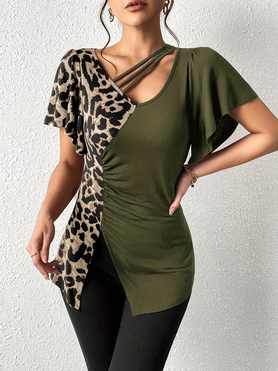 Ruched Leopard Flutter Sleeve T-ShirtIndulge in luxury with our Ruched Leopard Flutter Sleeve T-Shirt. The ruched detail and flutter sleeves add a touch of elegance to this already fierce leopard print Ruched Leopard Flutter SleeveRuched Leopard Flutter Sleeve