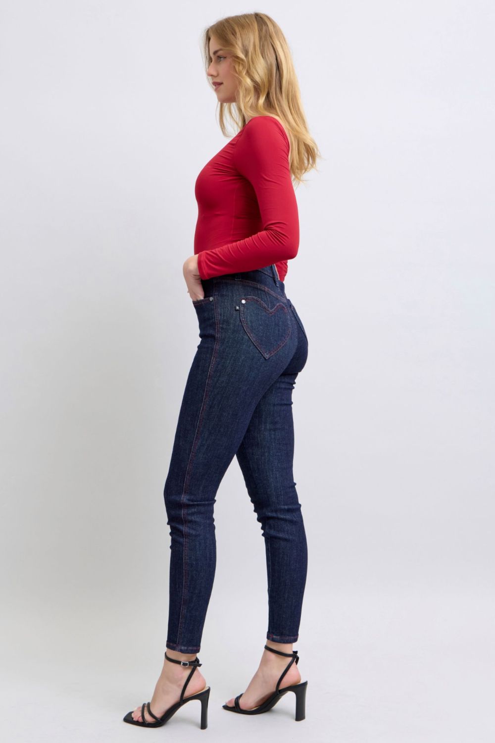 Judy Blue Full Size Heart Shaped Back Pockets Skinny JeansHigh Rise Heart-shaped back pockets on skinny jeans add a fun and playful twist to a classic style. These unique pockets can enhance your silhouette and create a flaJudy Blue Full Size Heart Shaped Back Pockets Skinny JeansJudy Blue Full Size Heart Shaped Back Pockets Skinny Jeans