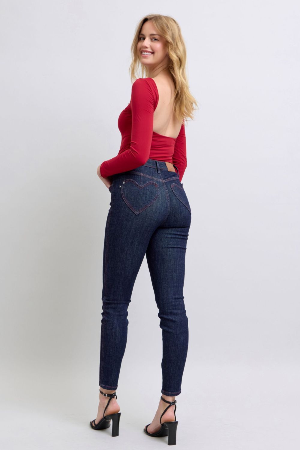 Judy Blue Full Size Heart Shaped Back Pockets Skinny JeansHigh Rise Heart-shaped back pockets on skinny jeans add a fun and playful twist to a classic style. These unique pockets can enhance your silhouette and create a flaJudy Blue Full Size Heart Shaped Back Pockets Skinny JeansJudy Blue Full Size Heart Shaped Back Pockets Skinny Jeans