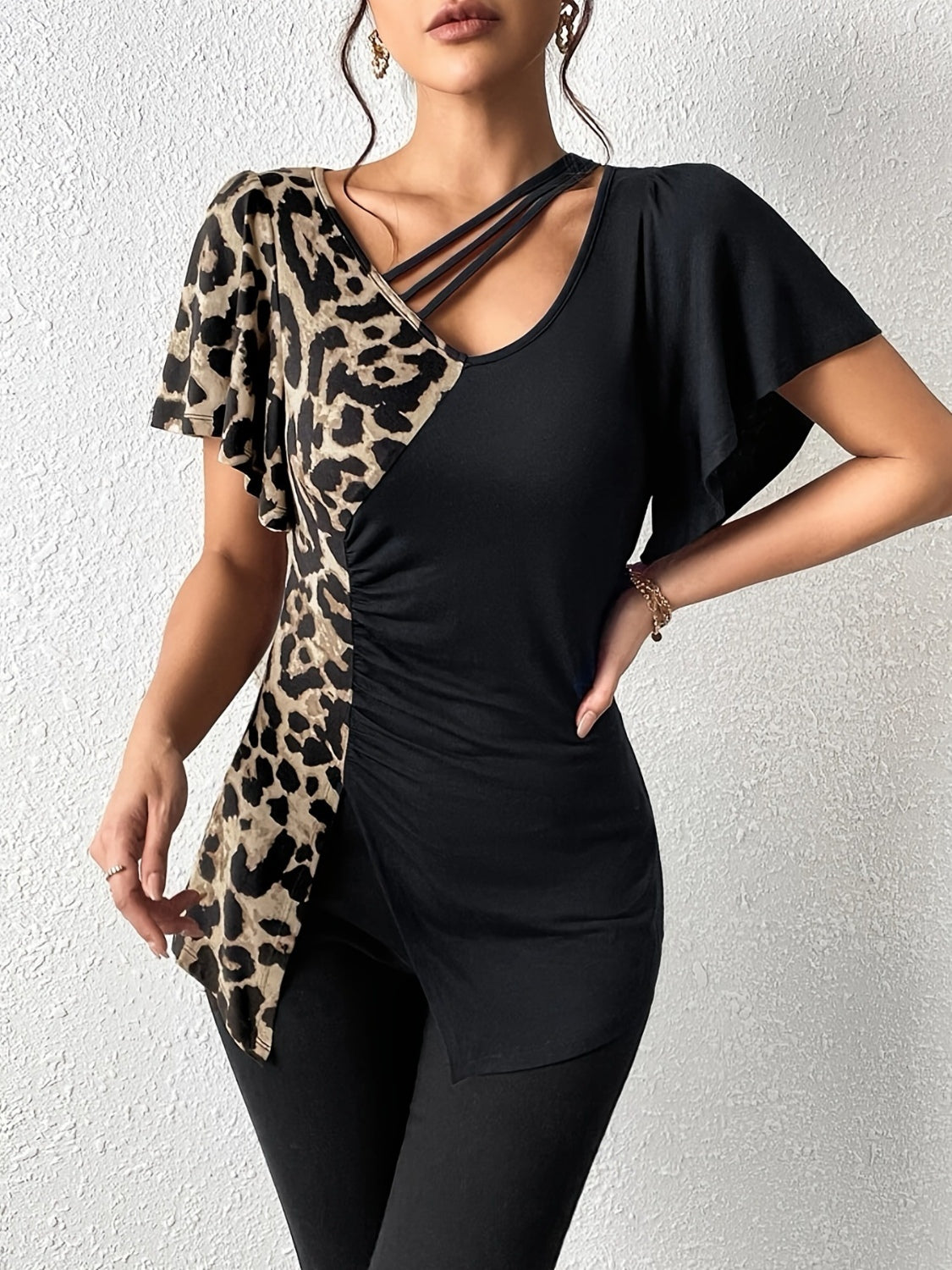 Ruched Leopard Flutter Sleeve T-ShirtIndulge in luxury with our Ruched Leopard Flutter Sleeve T-Shirt. The ruched detail and flutter sleeves add a touch of elegance to this already fierce leopard print Ruched Leopard Flutter SleeveRuched Leopard Flutter Sleeve