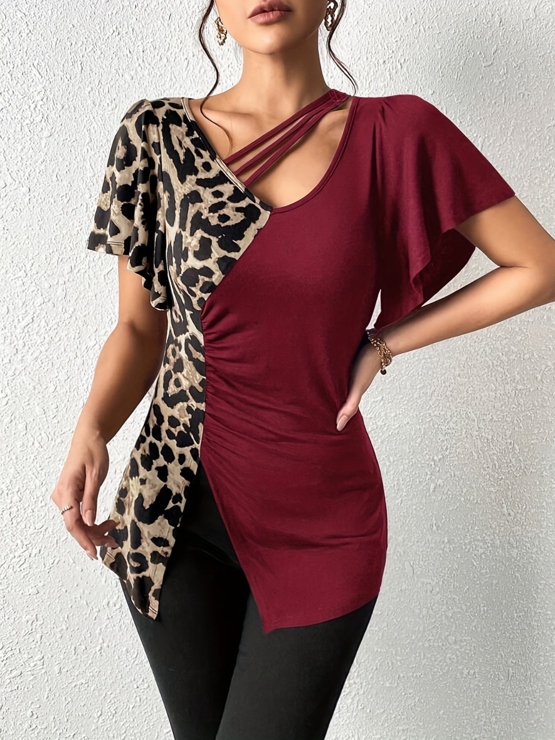 Ruched Leopard Flutter Sleeve T-ShirtIndulge in luxury with our Ruched Leopard Flutter Sleeve T-Shirt. The ruched detail and flutter sleeves add a touch of elegance to this already fierce leopard print Ruched Leopard Flutter SleeveRuched Leopard Flutter Sleeve