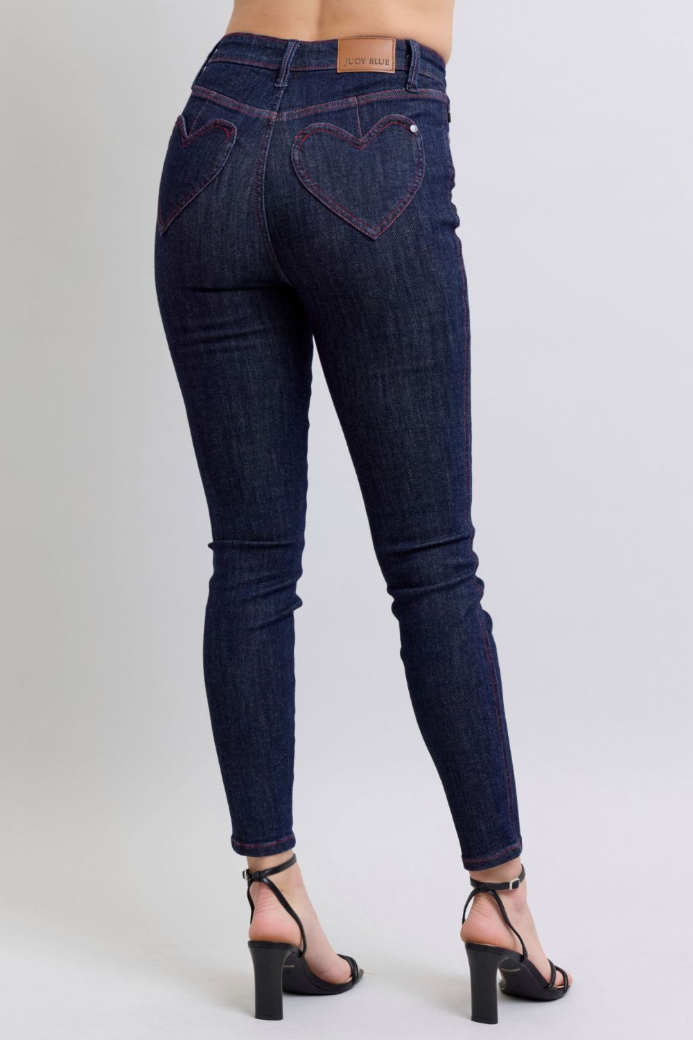 Judy Blue Full Size Heart Shaped Back Pockets Skinny JeansHigh Rise Heart-shaped back pockets on skinny jeans add a fun and playful twist to a classic style. These unique pockets can enhance your silhouette and create a flaJudy Blue Full Size Heart Shaped Back Pockets Skinny JeansJudy Blue Full Size Heart Shaped Back Pockets Skinny Jeans