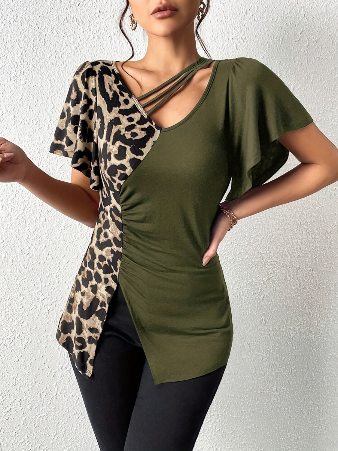 Ruched Leopard Flutter Sleeve T-ShirtIndulge in luxury with our Ruched Leopard Flutter Sleeve T-Shirt. The ruched detail and flutter sleeves add a touch of elegance to this already fierce leopard print Ruched Leopard Flutter SleeveRuched Leopard Flutter Sleeve