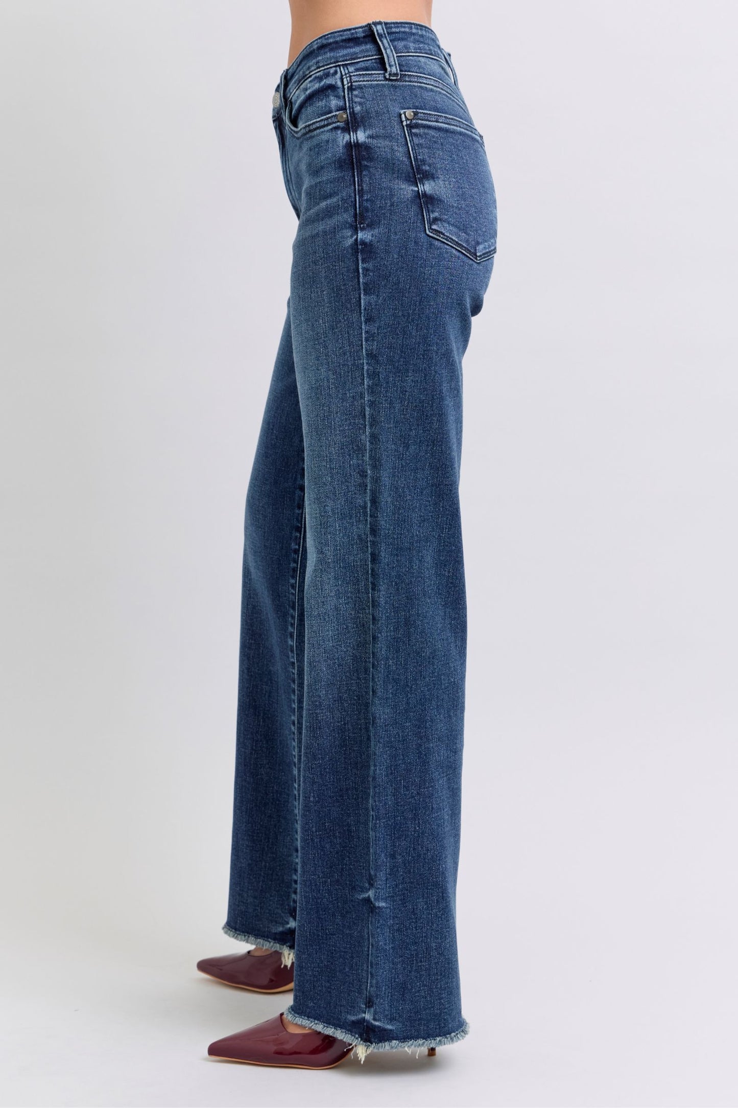 Judy Blue Full Size Raw Hem Mid Rise JeansRaw hem mid-rise jeans are a fashionable and on-trend denim style. The "raw hem" refers to the unfinished edge at the bottom of the jeans, creating a frayed or raw lJudy Blue Full Size Raw Hem Mid Rise JeansJudy Blue Full Size Raw Hem Mid Rise Jeans