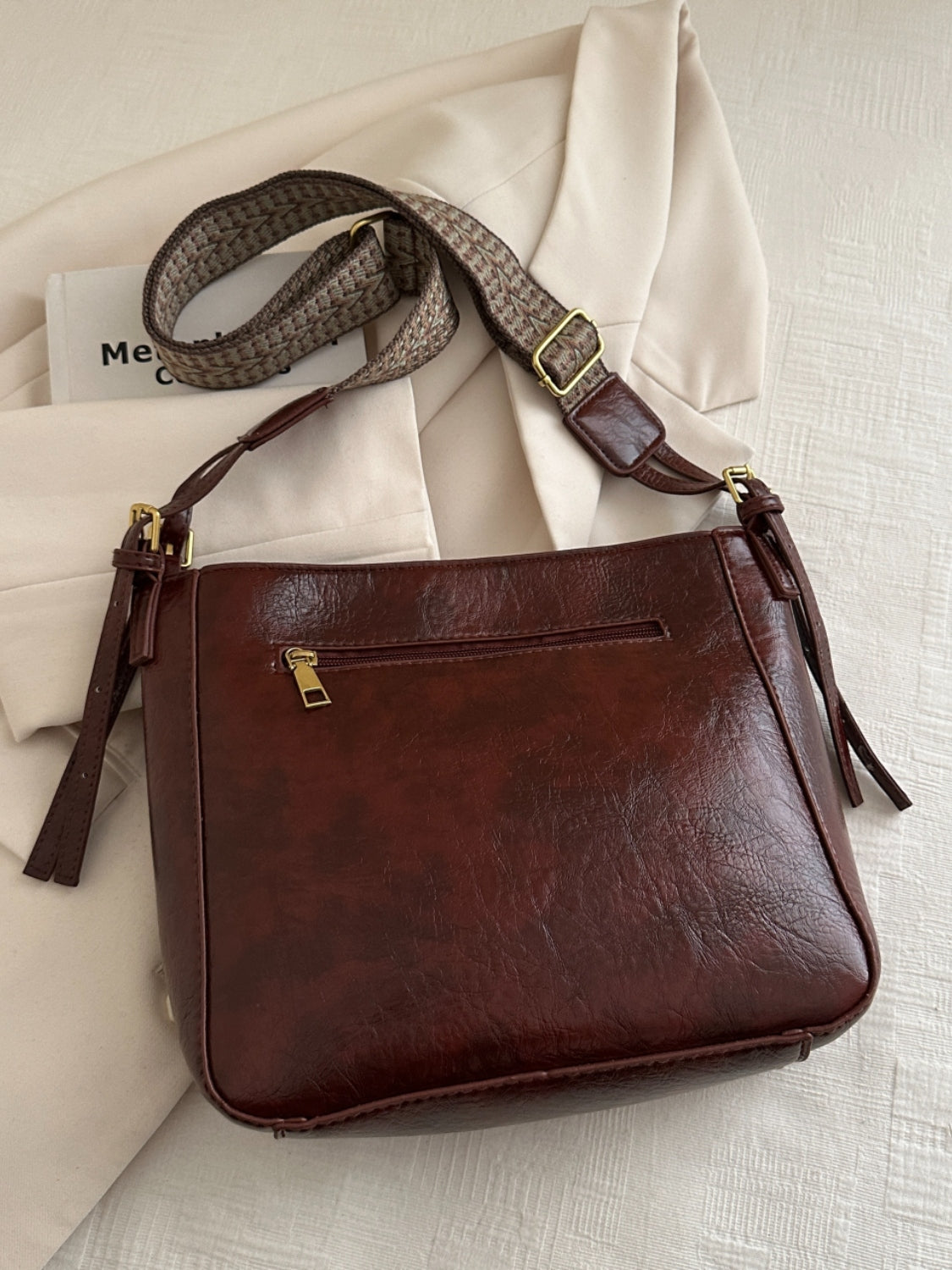 PU Leather Adjustable Strap Crossbody Bag with PouchBag size: Medium
Material: PU leather
Imported
Product Measurements (Measurements by inches) &amp; Size Conversion

Size
Actual Length
Actual Width
Actual Height


OPU Leather Adjustable Strap Crossbody BagPU Leather Adjustable Strap Crossbody Bag