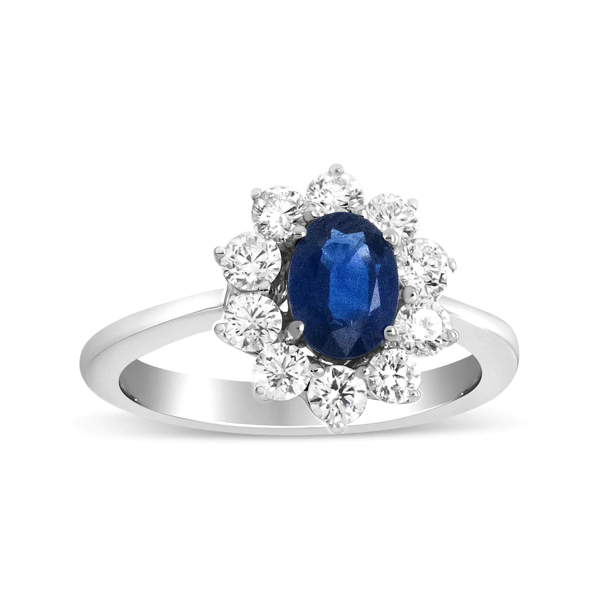 18K White Gold Oval Cut Blue Sapphire  Sunburst Halo RingA ring that mirrors that of Diane's, this 18k white gold is beautifully set with a deep blue sapphire gemstone at its center. This 7x5mm stone is flanked by a floral18K White Gold Oval Cut Blue Sapphire Sunburst Halo RingRings18K White Gold Oval Cut Blue Sapphire Sunburst Halo Ring