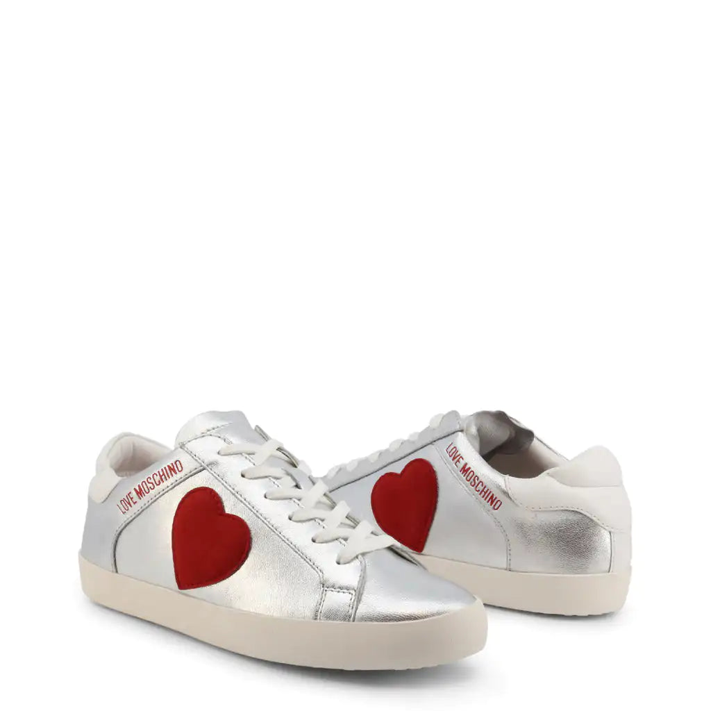 Silver Heart SneakersStrut your stuff in these Love Moschino silver heart sneakers.  These logo shoes feature a red heart on the side.Add a touch of sparkle to your stride with our SilveSilver Heart SneakersSilver Heart Sneakers