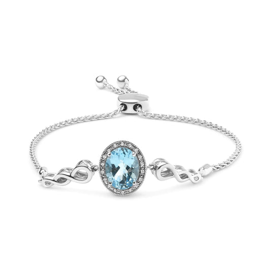 Sterling silver lariat bolo bracelet with oval blue topaz center and diamond accents.