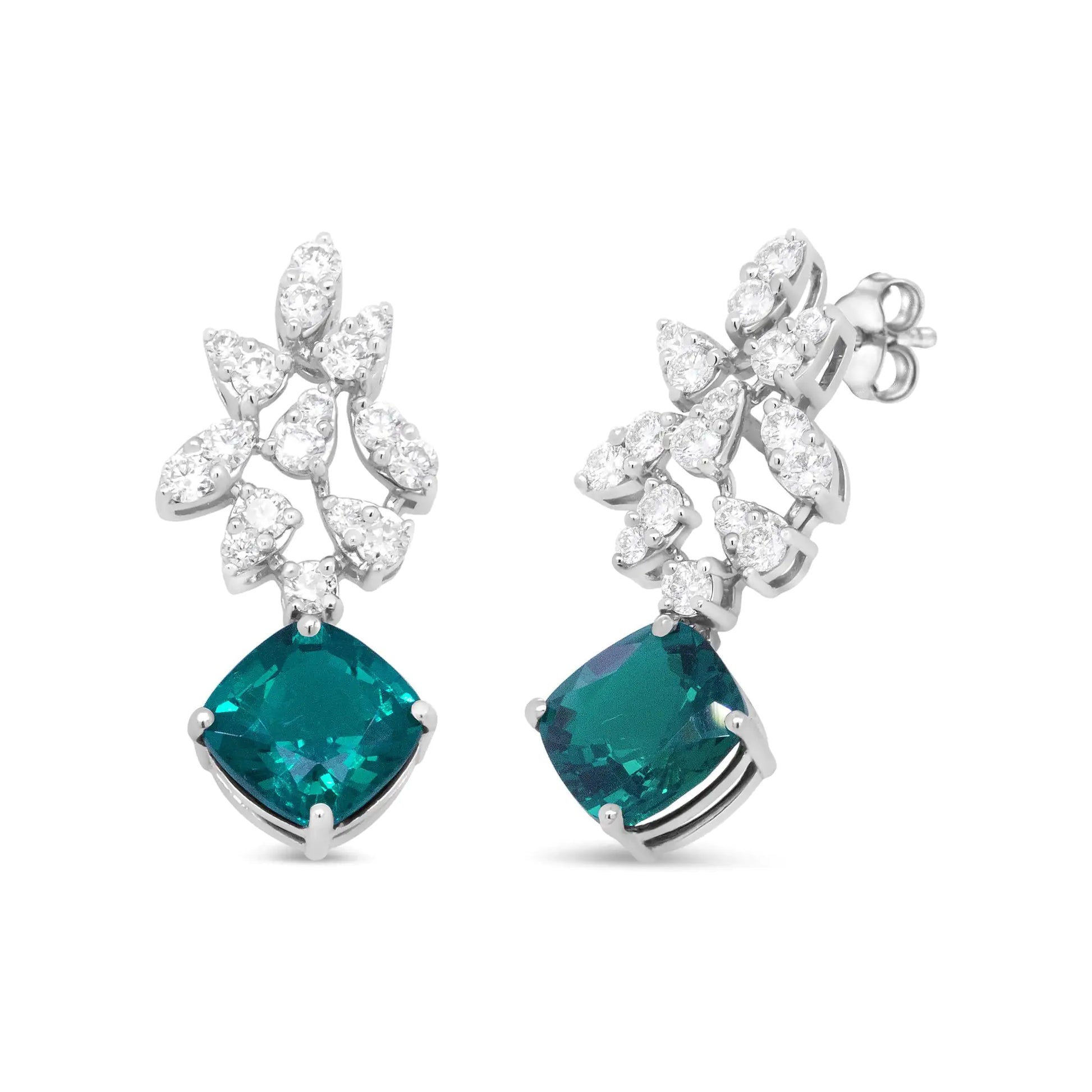 18K White Gold 1 1/10 Cttw Diamond and 7.9 x 7.7mm Green Emerald Drop Elevate your style with the rich sparkle that gleams from these gemstone and diamond drop earrings made from genuine 18k white gold. The upper dangle of this brillia7Earrings7