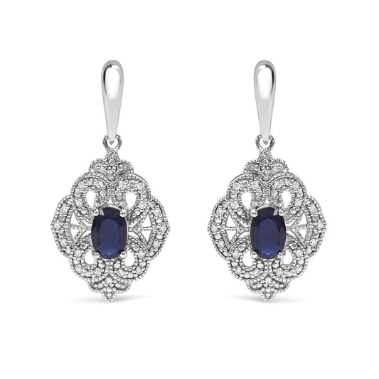 Sterling Silver Oval Blue Sapphire and White Diamond Accent Art Deco SEmbark on a journey of timeless elegance with these exquisite Art Deco-inspired shield dangle earrings. Crafted from the finest .925 sterling silver, they showcase tWhite Diamond Accent Art Deco Style Shield Dangle EarringWhite Diamond Accent Art Deco Style Shield Dangle Earring