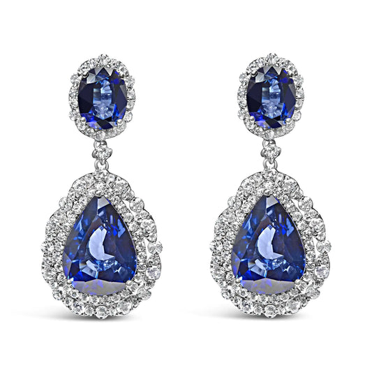 Elegant 18K white gold blue sapphire diamond halo drop earrings for women.