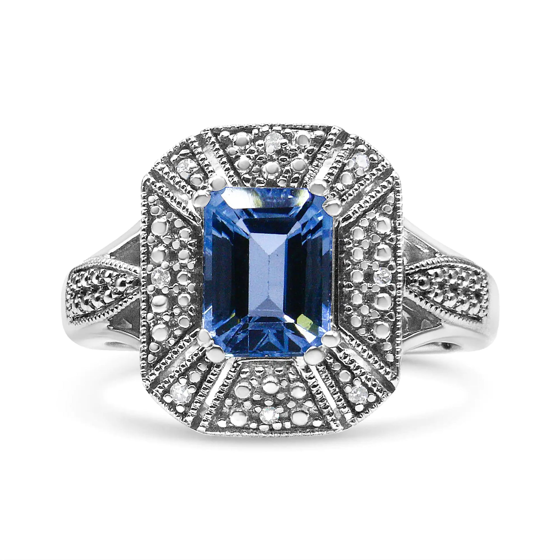 Sterling silver ring with emerald-cut blue topaz and diamond accents.