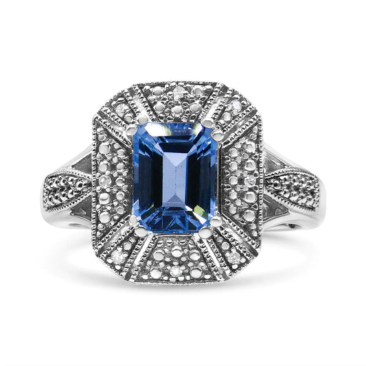 Sterling silver ring with emerald-cut blue topaz and diamond accents.