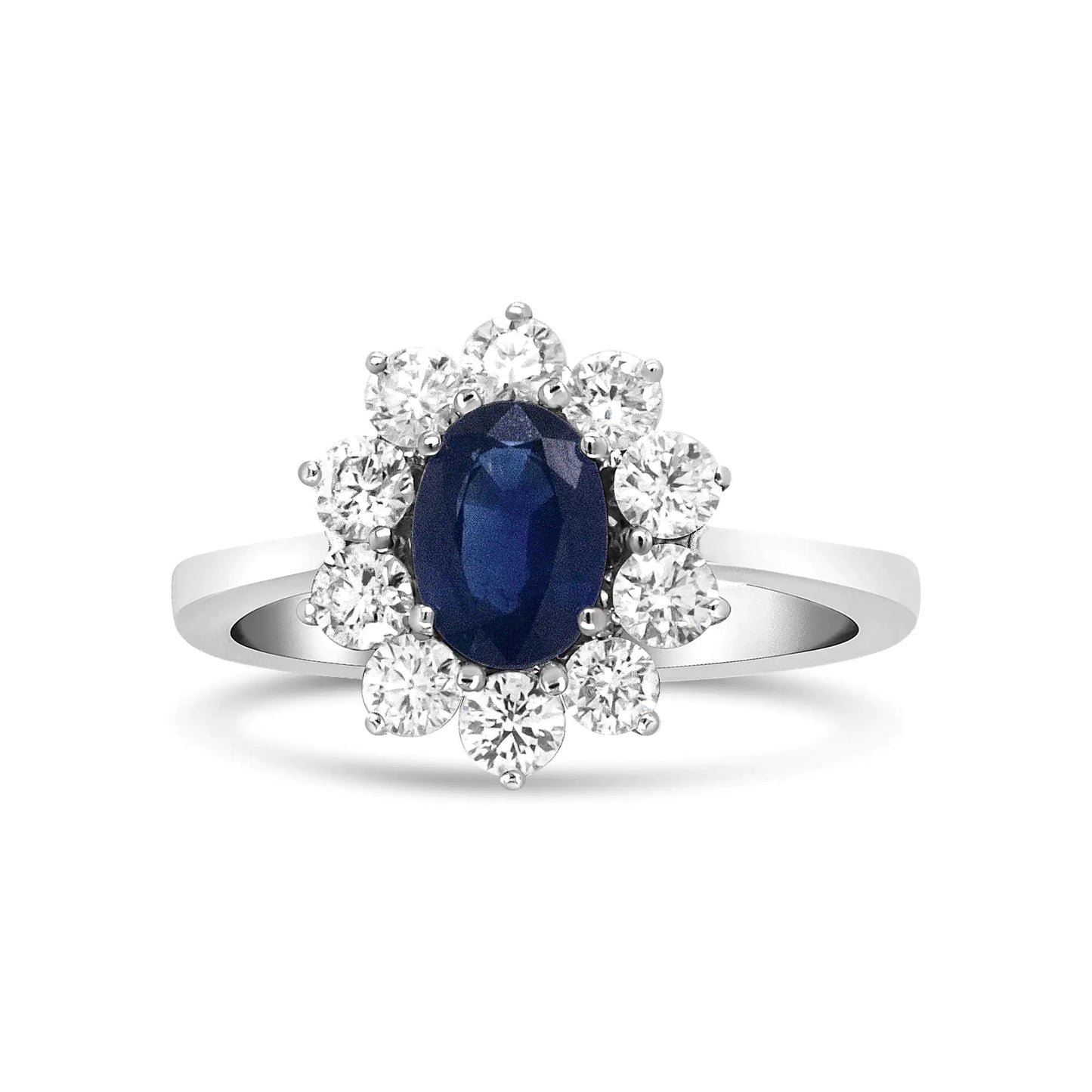 18K white gold ring with oval blue sapphire and sunburst halo of round-cut diamonds.