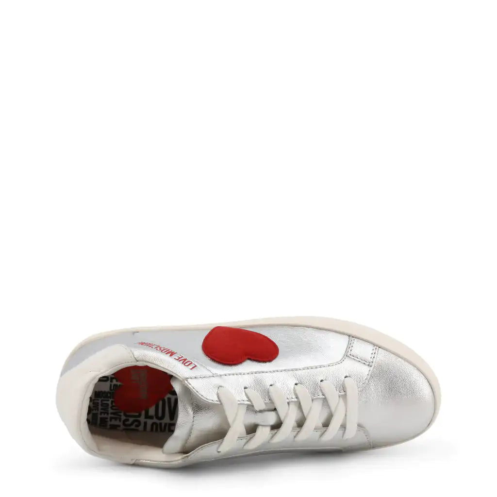 Silver Heart SneakersStrut your stuff in these Love Moschino silver heart sneakers.  These logo shoes feature a red heart on the side.Add a touch of sparkle to your stride with our SilveSilver Heart SneakersSilver Heart Sneakers