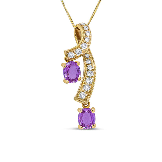 14K Yellow Gold 6x4mm Oval Pink Sapphire and 1/5 Cttw Round Diamond PeThis unique pendant necklace is sure to turn heads. The pendant features a a ribbon of diamond accented 14K Yellow Gold weaving through down neckline. The diamond st14K Yellow Gold 6x4mm Oval Pink Sapphire14K Yellow Gold 6x4mm Oval Pink Sapphire