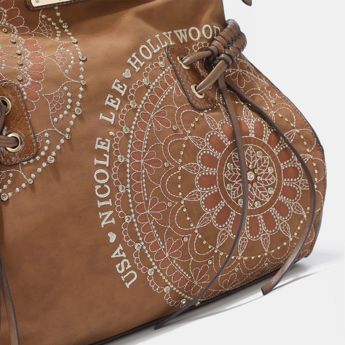 Nicole Lee USA Side Braided Tassel Inlaid Rhinestone Embroidery Hobo BEqually casual and chic, our hobo bag is an effortless fashion statement with its laid-back silhouette and expertly embroidered design.
Bag size: Medium
Material: VeNicole Lee USA Side Braided TasselNicole Lee USA Side Braided Tassel