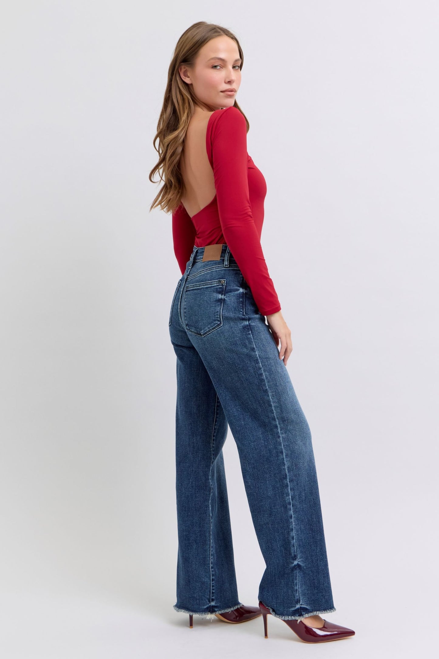 Judy Blue Full Size Raw Hem Mid Rise JeansRaw hem mid-rise jeans are a fashionable and on-trend denim style. The "raw hem" refers to the unfinished edge at the bottom of the jeans, creating a frayed or raw lJudy Blue Full Size Raw Hem Mid Rise JeansJudy Blue Full Size Raw Hem Mid Rise Jeans