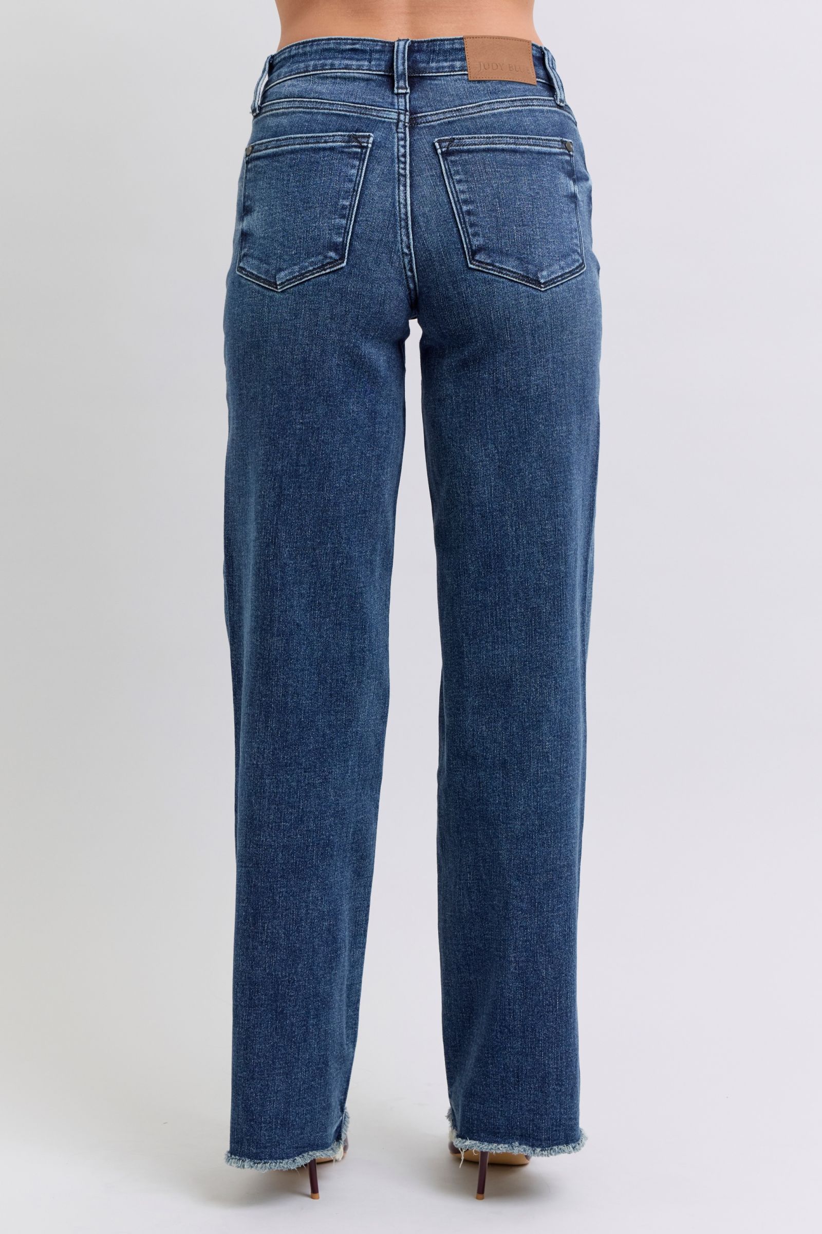 Judy Blue Full Size Raw Hem Mid Rise JeansRaw hem mid-rise jeans are a fashionable and on-trend denim style. The "raw hem" refers to the unfinished edge at the bottom of the jeans, creating a frayed or raw lJudy Blue Full Size Raw Hem Mid Rise JeansJudy Blue Full Size Raw Hem Mid Rise Jeans