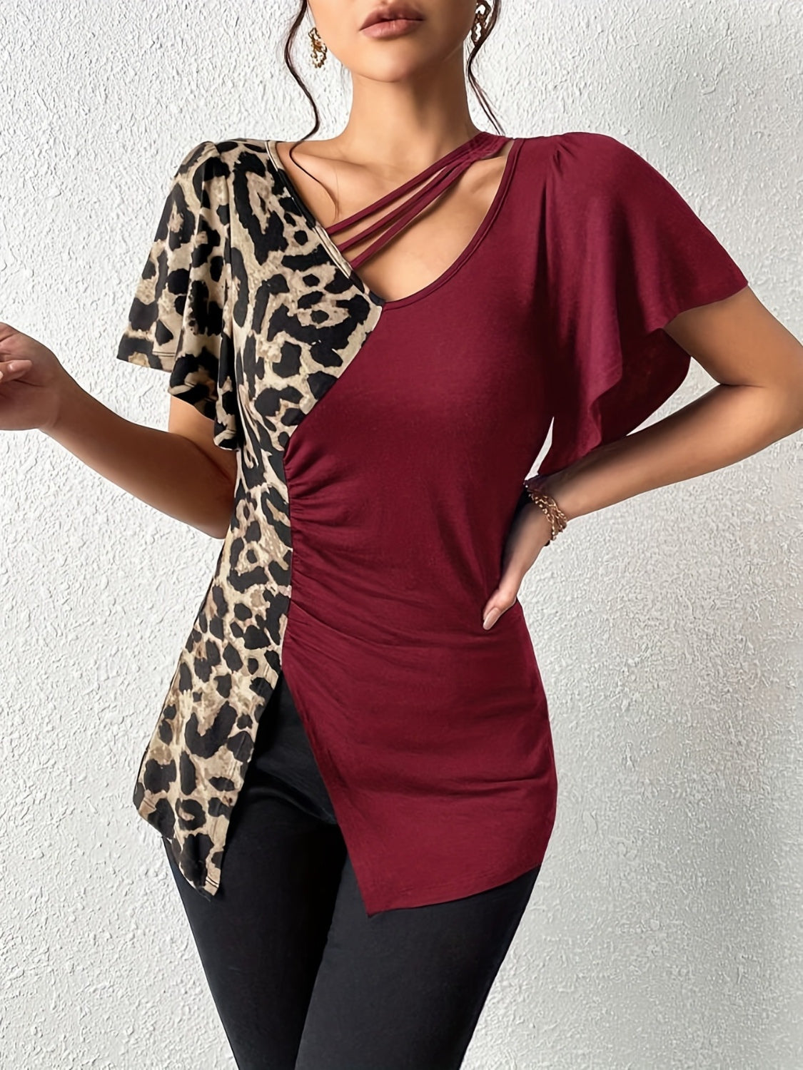 Ruched Leopard Flutter Sleeve T-ShirtIndulge in luxury with our Ruched Leopard Flutter Sleeve T-Shirt. The ruched detail and flutter sleeves add a touch of elegance to this already fierce leopard print Ruched Leopard Flutter SleeveRuched Leopard Flutter Sleeve