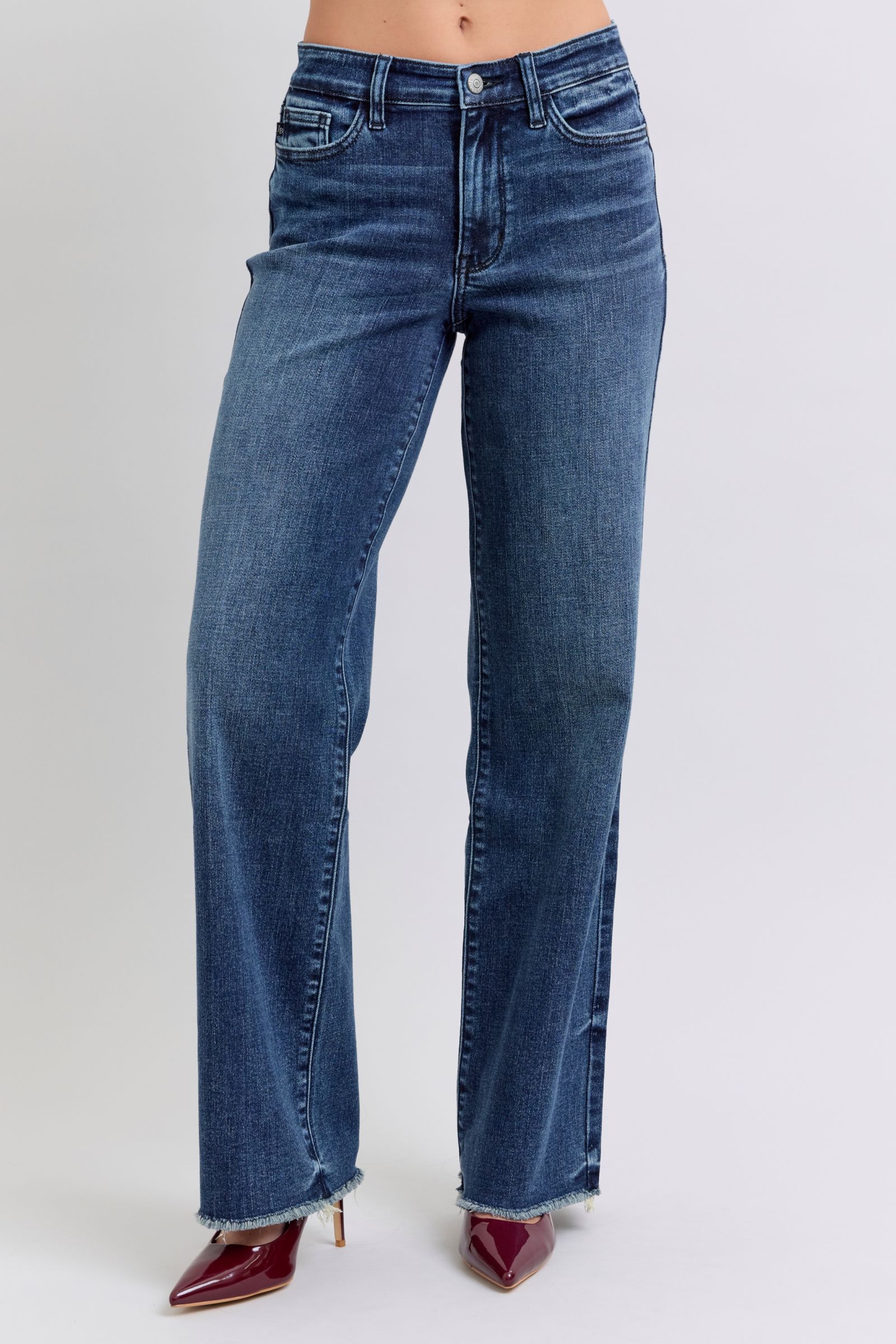 Judy Blue Full Size Raw Hem Mid Rise JeansRaw hem mid-rise jeans are a fashionable and on-trend denim style. The "raw hem" refers to the unfinished edge at the bottom of the jeans, creating a frayed or raw lJudy Blue Full Size Raw Hem Mid Rise JeansJudy Blue Full Size Raw Hem Mid Rise Jeans