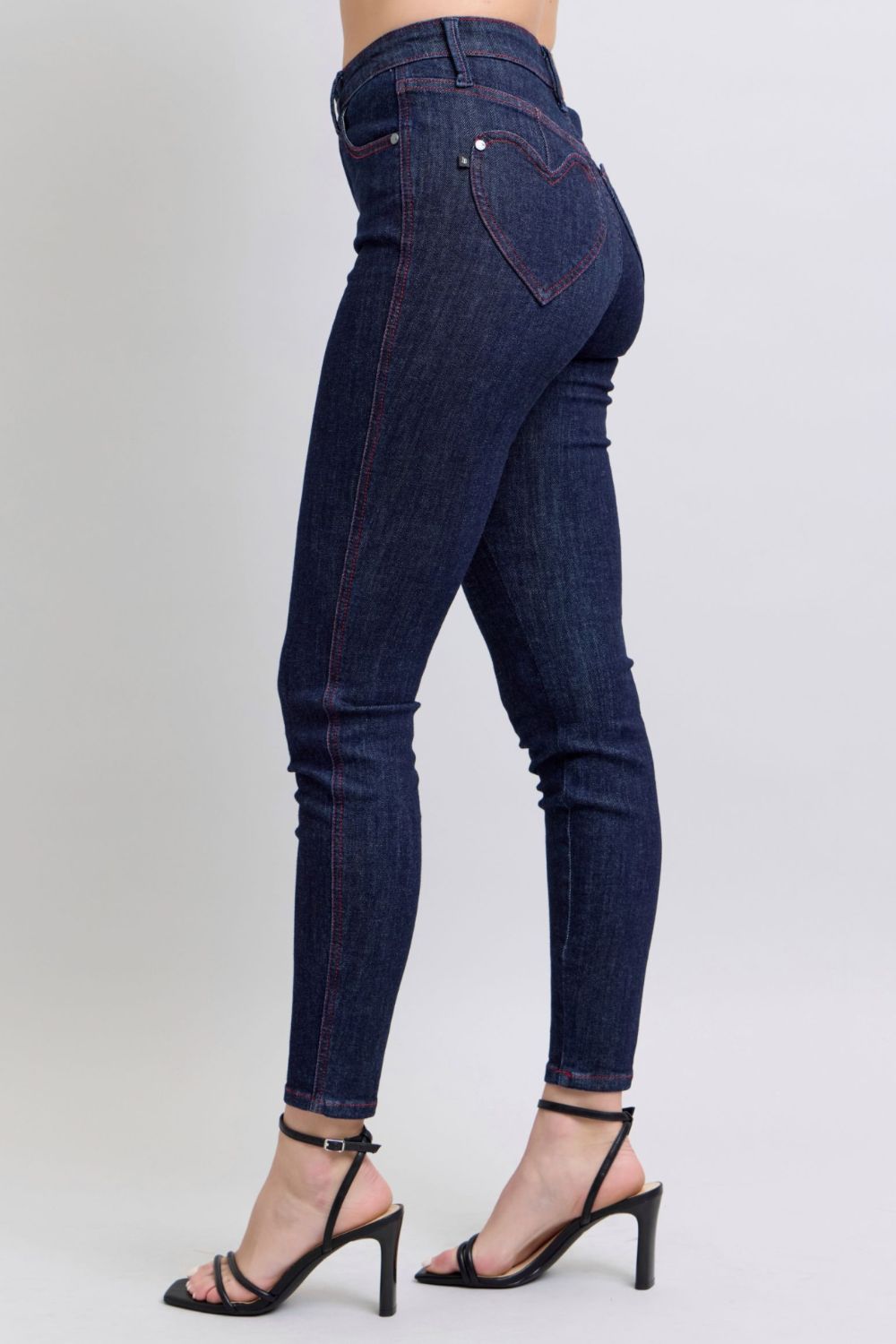 Judy Blue Full Size Heart Shaped Back Pockets Skinny JeansHigh Rise Heart-shaped back pockets on skinny jeans add a fun and playful twist to a classic style. These unique pockets can enhance your silhouette and create a flaJudy Blue Full Size Heart Shaped Back Pockets Skinny JeansJudy Blue Full Size Heart Shaped Back Pockets Skinny Jeans