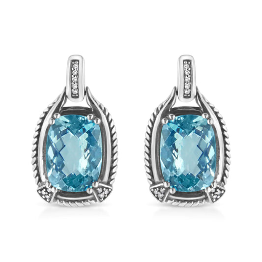 Sterling silver dangle earrings with cushion cut blue topaz and diamond accents.