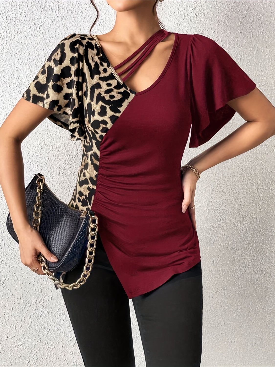 Ruched Leopard Flutter Sleeve T-ShirtIndulge in luxury with our Ruched Leopard Flutter Sleeve T-Shirt. The ruched detail and flutter sleeves add a touch of elegance to this already fierce leopard print Ruched Leopard Flutter SleeveRuched Leopard Flutter Sleeve