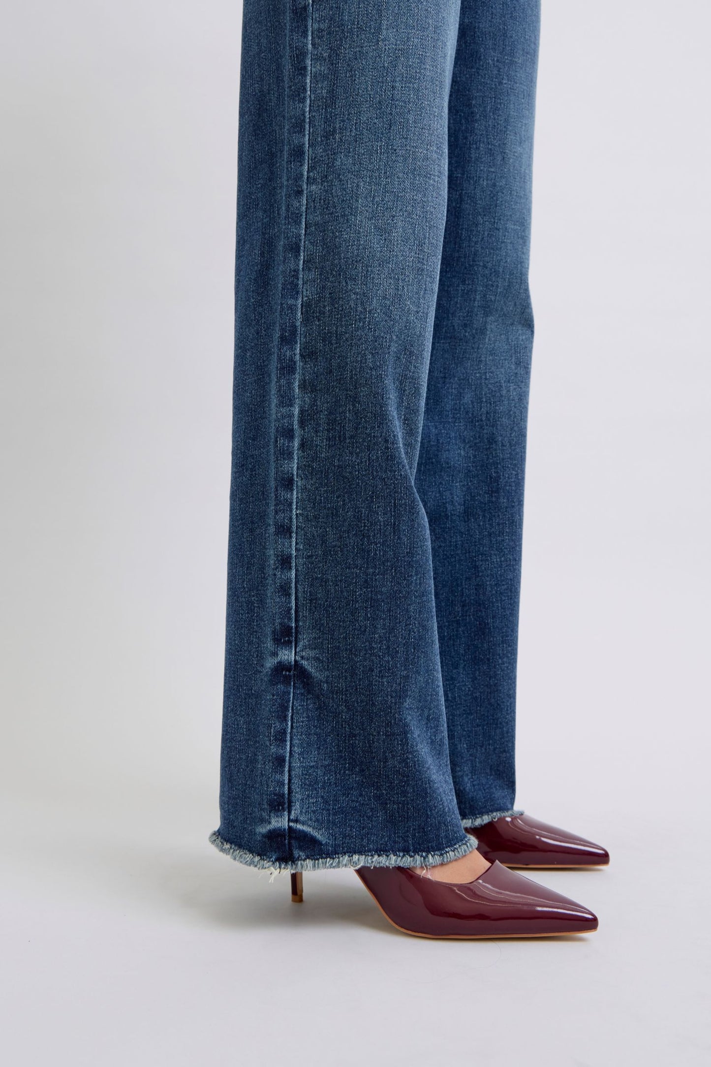 Judy Blue Full Size Raw Hem Mid Rise JeansRaw hem mid-rise jeans are a fashionable and on-trend denim style. The "raw hem" refers to the unfinished edge at the bottom of the jeans, creating a frayed or raw lJudy Blue Full Size Raw Hem Mid Rise JeansJudy Blue Full Size Raw Hem Mid Rise Jeans