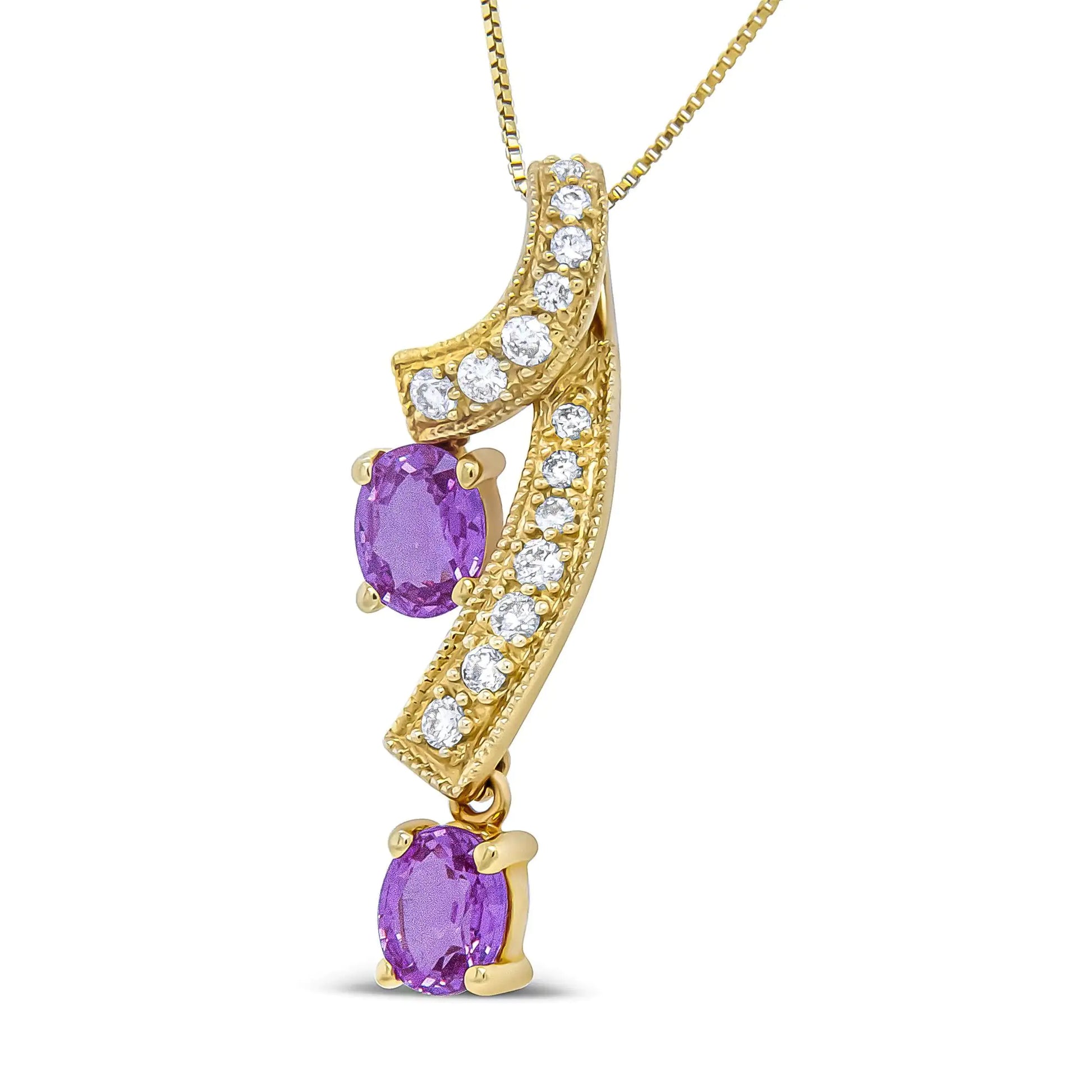 14K Yellow Gold 6x4mm Oval Pink Sapphire and 1/5 Cttw Round Diamond PeThis unique pendant necklace is sure to turn heads. The pendant features a a ribbon of diamond accented 14K Yellow Gold weaving through down neckline. The diamond st14K Yellow Gold 6x4mm Oval Pink Sapphire14K Yellow Gold 6x4mm Oval Pink Sapphire