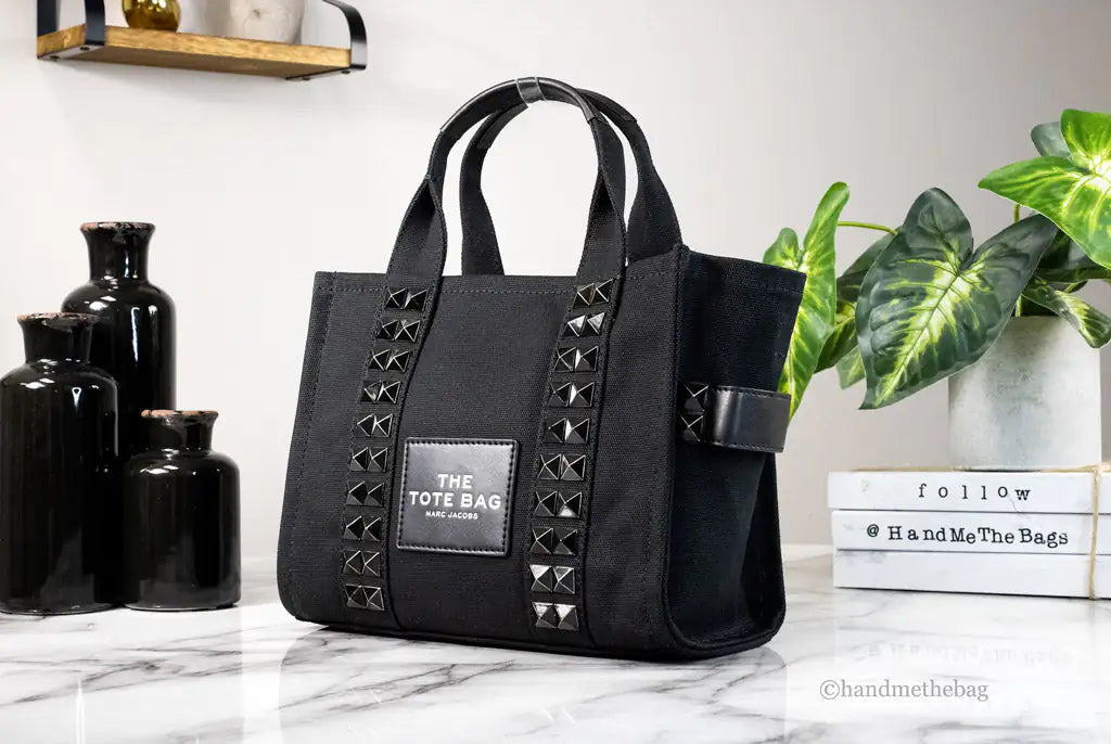 Marc Jacobs The Studded Mini Tote Black Cotton Canvas Crossbody HandbaMarc Jacobs The Studded Mini Tote – Black Cotton Canvas Crossbody HandbagMake a bold statement with Marc Jacobs The Studded Mini Tote in black cotton canvas. This stStudded Mini Tote Black Cotton Canvas Crossbody Handbag PurseStudded Mini Tote Black Cotton Canvas Crossbody Handbag Purse