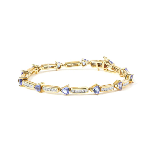 14K yellow gold bracelet with 5mm trillion cut blue tanzanite and diamond accents, 7 inches.